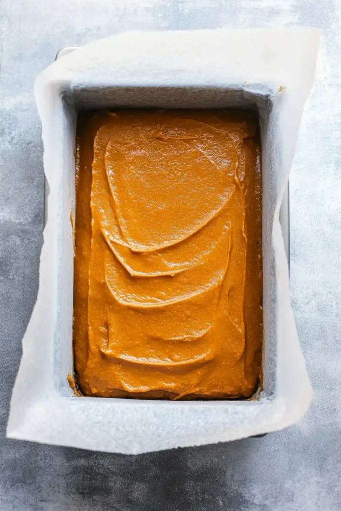 pumpkin batter poured into a loaf pan